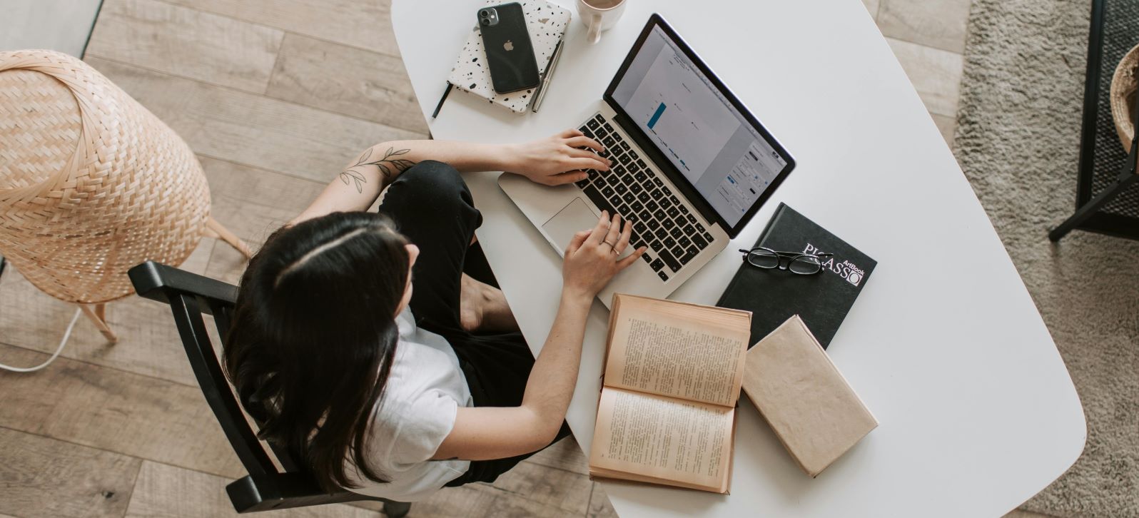 bird's eye view of person working from home on their laptop 