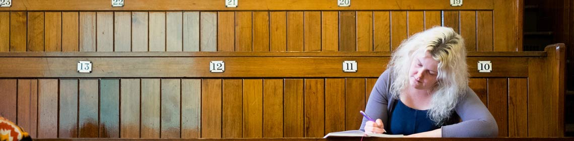 Photo of a PhD researcher in a lecture theatre