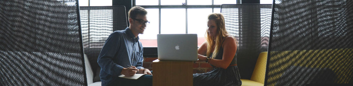 man and woman chatting over laptop