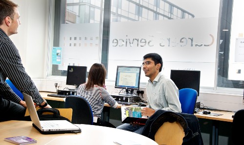 Person in an office talking to a colleague 