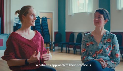 Video still of two women chatting 