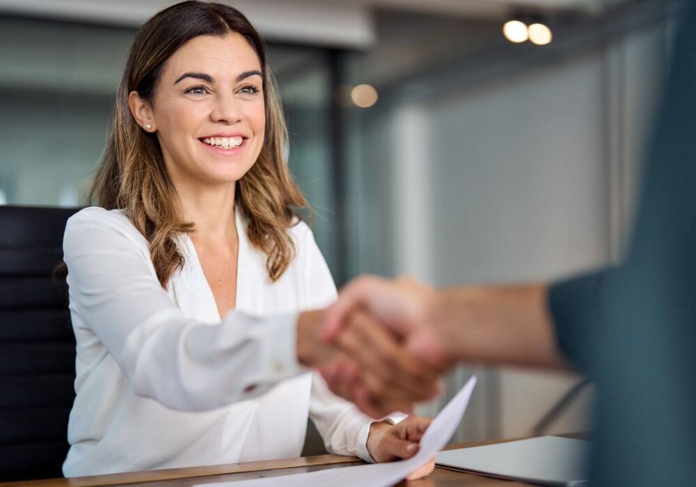 Woman shaking hand on interviewee