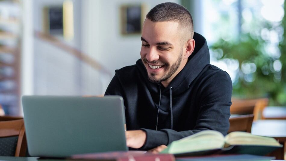 A man sat at a laptop