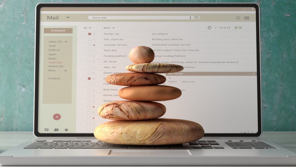 A laptop with Zen rocks on top of the keyboard