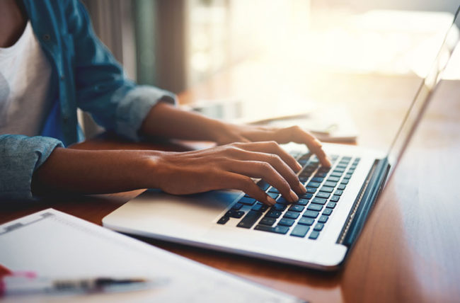 person typing on laptop