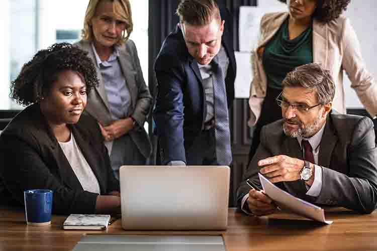 Group discussing around a computer