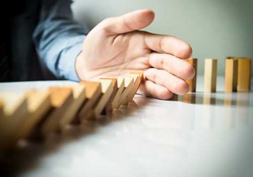 Hand stopping dominoes 