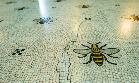 Mosaic white tiles with a yellow and black bee