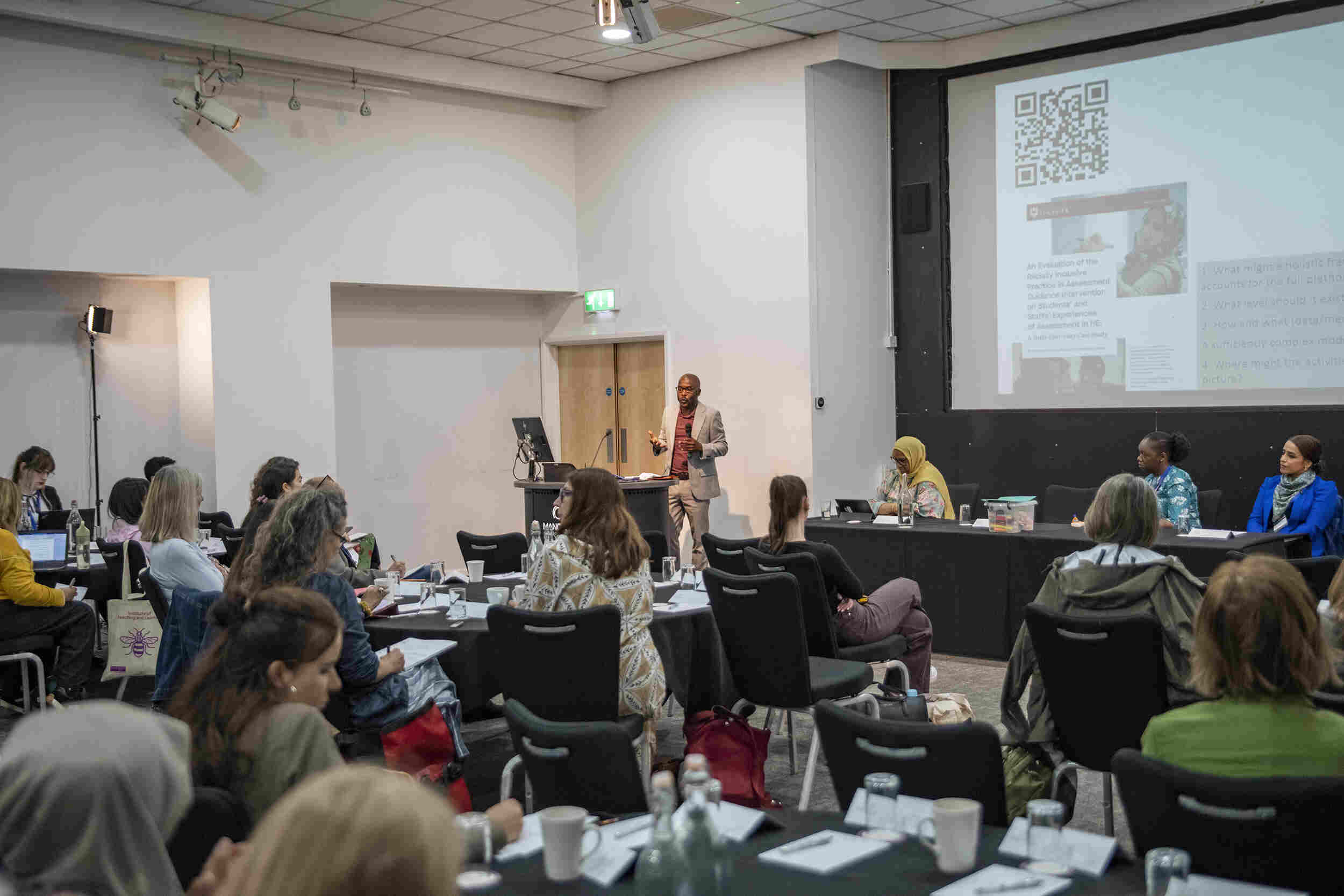 An image of speakers at the first plenary session of the conference.