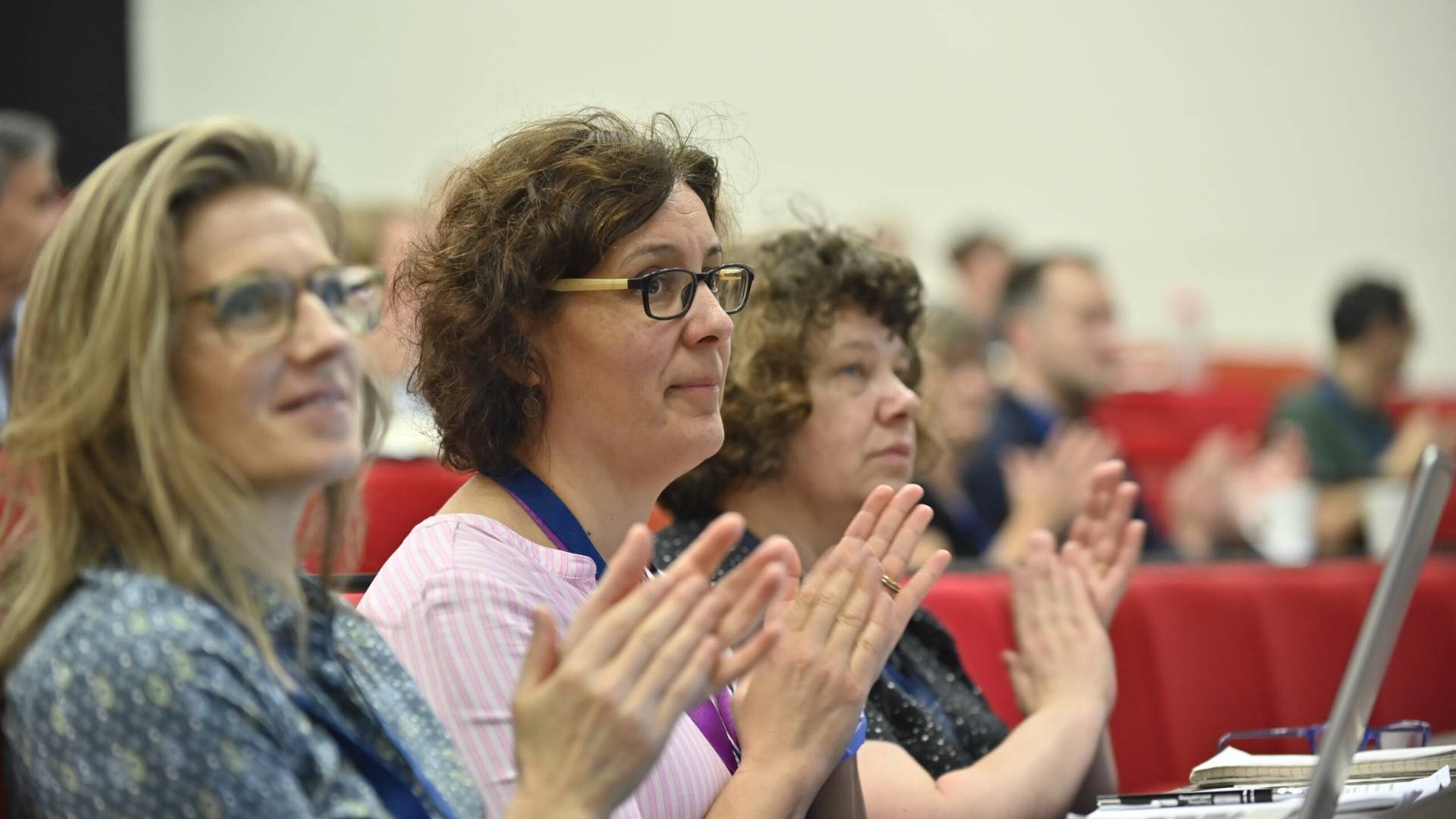 An image of the audience clapping after the final plenary talks.