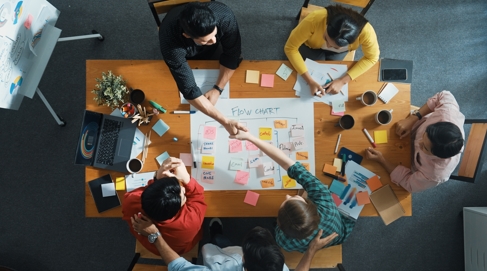 an image of people working at a table collaboratively